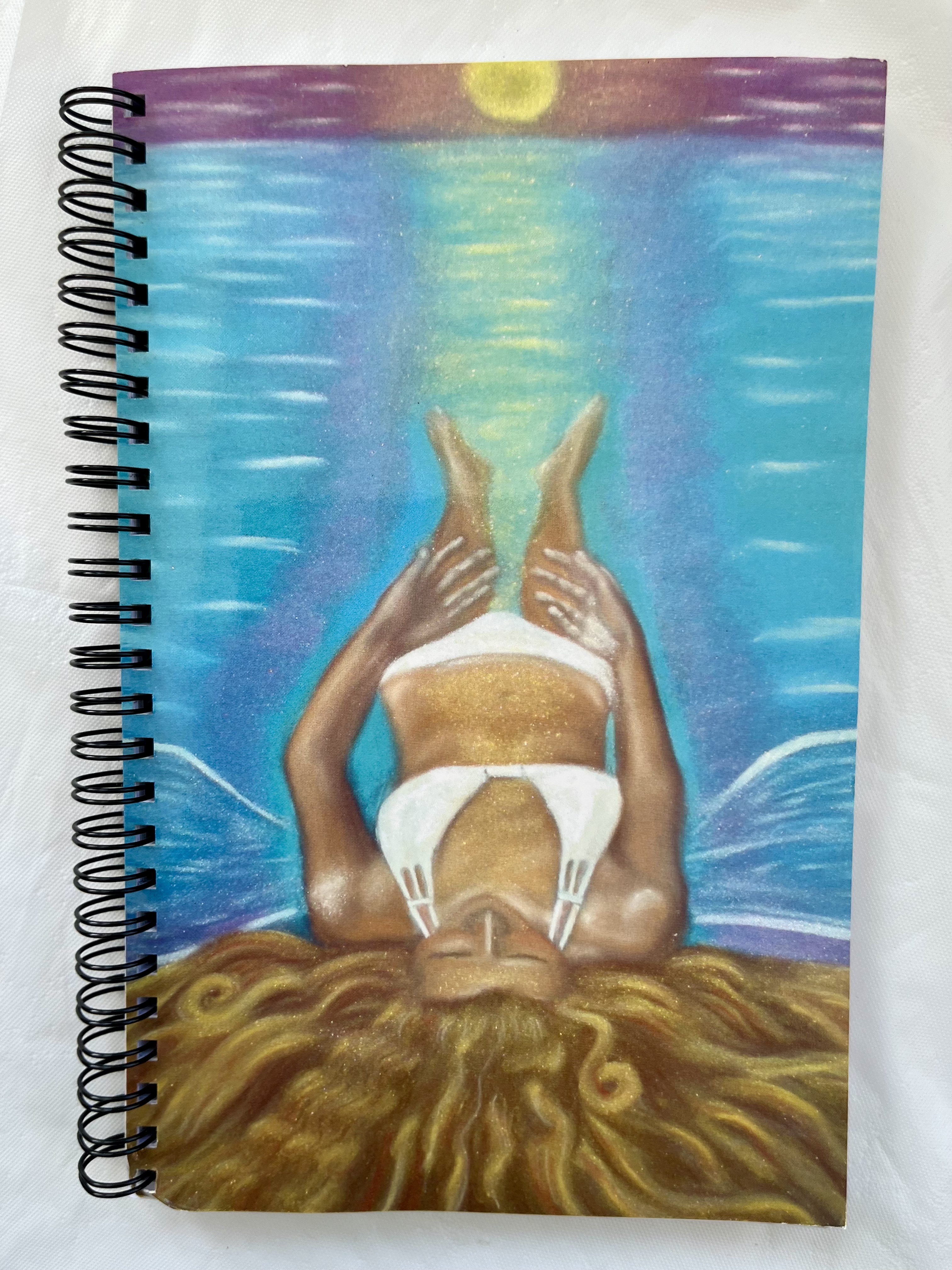 notebook with longtide painting and light code activated